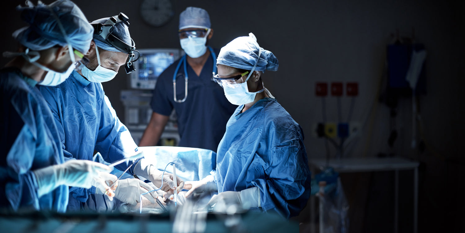 Surgeons in an operating room performing surgery.